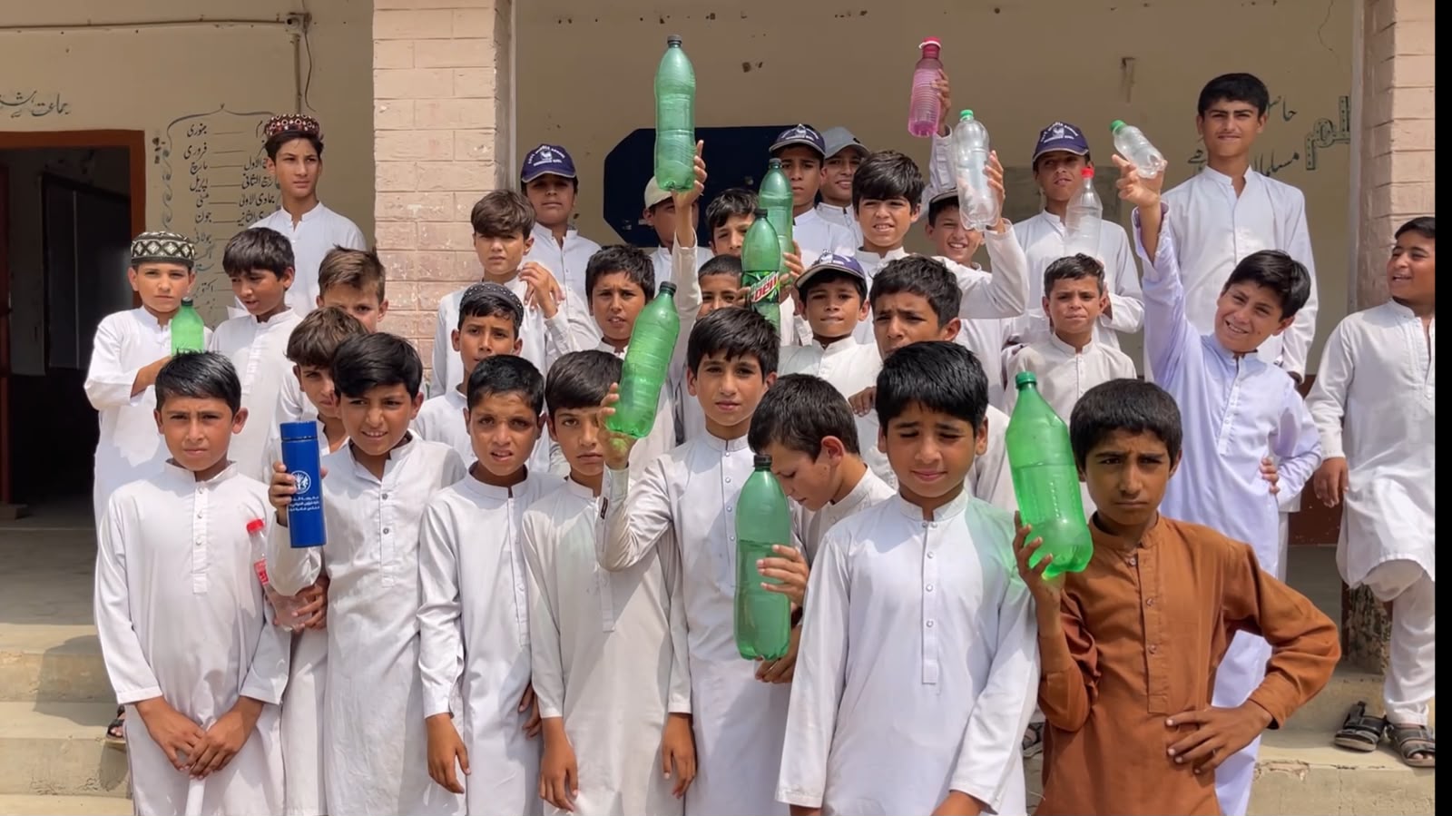 carrying-water-bottles-and-hand-fans-karak-students-seek-basic-facilities